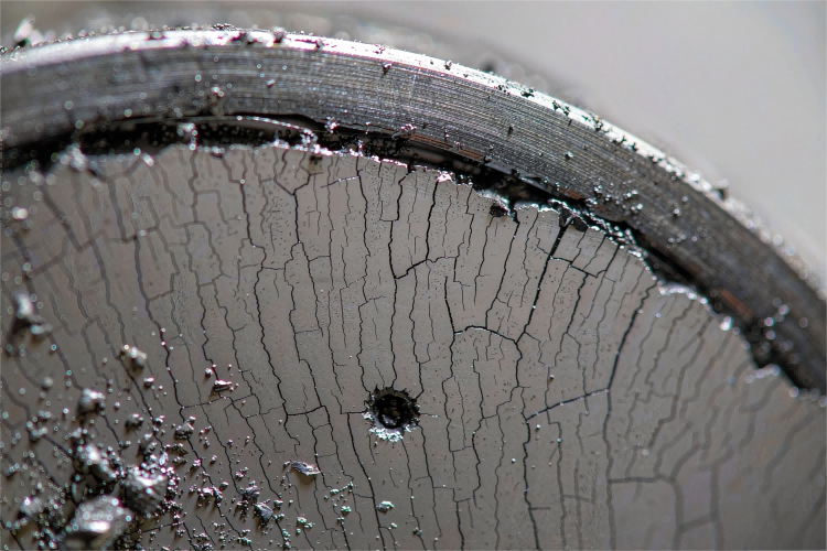 Sputtering Target Cracking close-up showing surface cracks, arc craters, and sputtering spatter marks